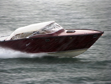 What a beautiful boat!  It makes up for the less than optimal weather.  This photo of a Motor or Power Boat on Lake Zurich in Switzerland is used courtesy of "Roland zh" and the Creative Commons Attribution ShareAlike 3.0 License. (http://commons.wikimedia.org/wiki/File:Z%C3%BCrichsee_-_Speedboat_IMG_2996.jpg)